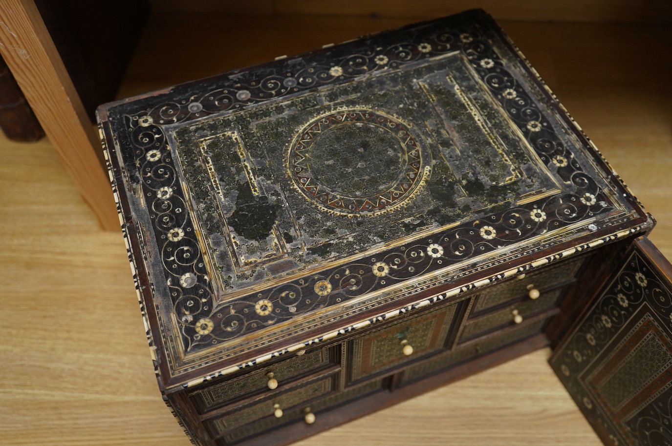 An early 17th century Indo-Portuguese ivory inlaid table cabinet, Gujarat, 29cm high. Condition - poor, losses CITES Submission reference 3XBFQXPT